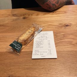 a receipt and a sandwich on a table a receipt and a sandwich on a table