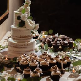 a wedding cake and cupcakes a wedding cake and cupcakes