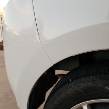 Ultimate Auto Touch-Ups - Finished result - A white vehicle's front fender and tire are visible, with a noticeable gap indicating possible damage or misalignment. - Body Shops Near Me - Chandler, Arizona