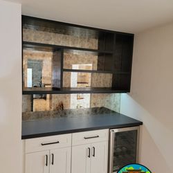 World kitchen Cabinets and Vanities Corporation - White kitchen cabinets with a black countertop