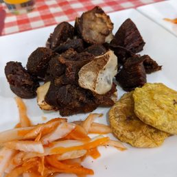 Fried goat / tassot cabrit served with pikliz, rice, and fried banana. Really tasty. Highly recommended Fried goat / tassot cabrit served with pikliz, rice, and fried banana. Really tasty. Highly recommended