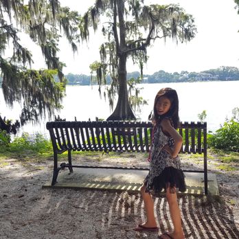 Kraft Azalea Garden - One of the many benches to enjoy the view of the lake and my little model Sierra who kept on wanting to get in my photos. - Parks Near Me - Winter Park, Florida