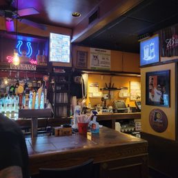 a bar with a television and a bar counter a bar with a television and a bar counter