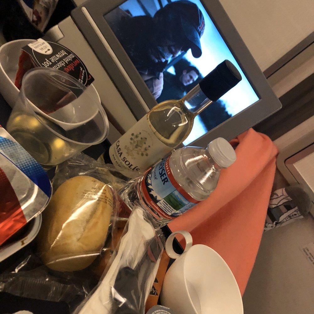 British Airways - All the goodies for my flight to London- all Complimentary  Wine, dessert, curry chicken and Angel has Fallen for my movie - Airlines Near Me - Dulles, Virginia