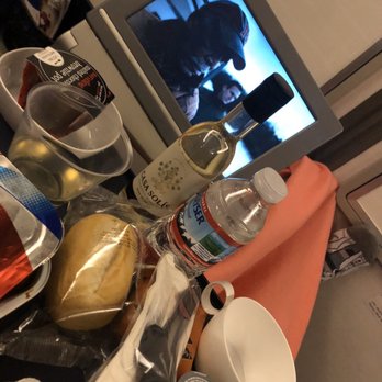 British Airways - All the goodies for my flight to London- all Complimentary  Wine, dessert, curry chicken and Angel has Fallen for my movie - Airlines Near Me - Dulles, Virginia