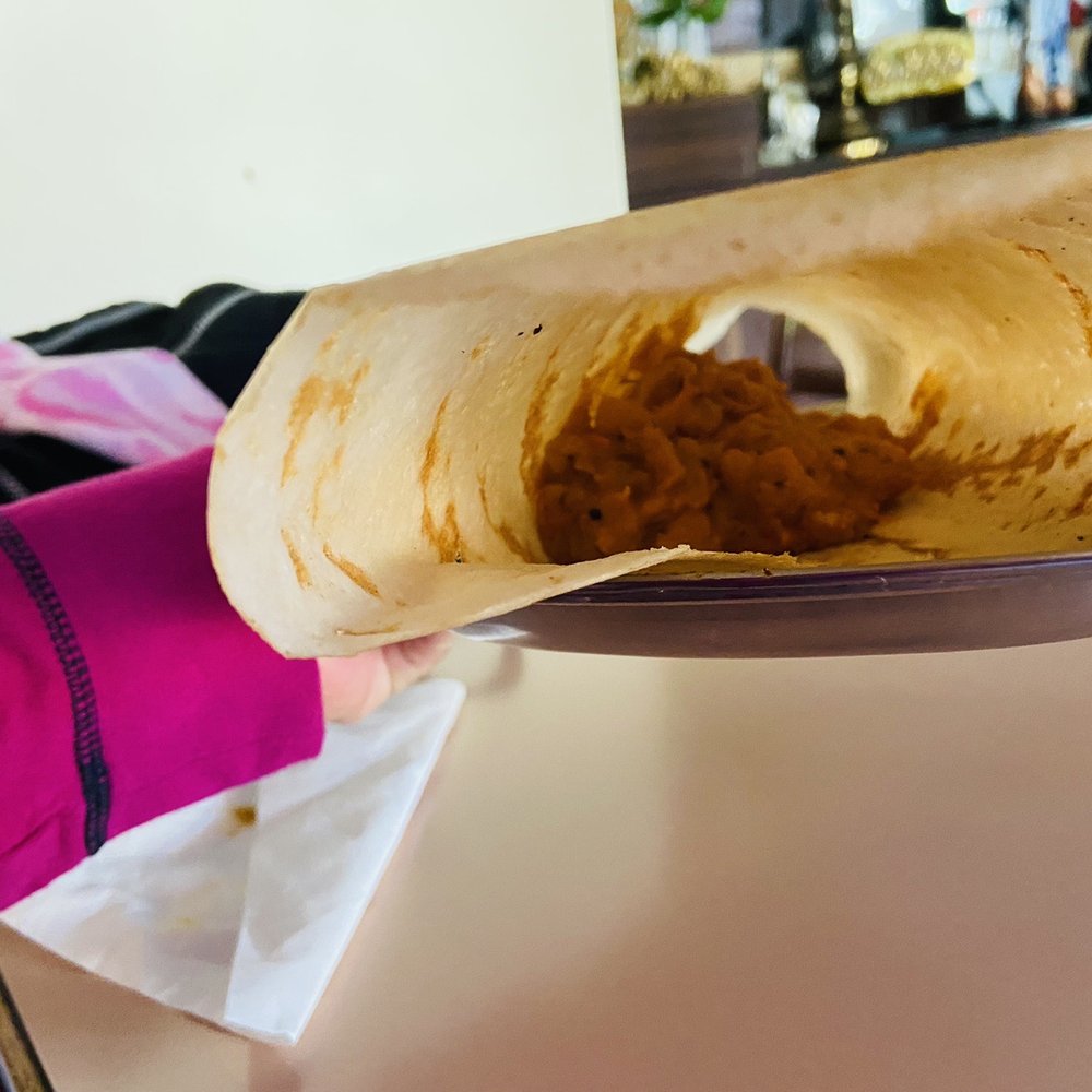 Chettinad Dosa Palace - a person holding a plate of dosa - Indian Near Me - Burnaby, British Columbia Chettinad Dosa Palace - a person holding a plate of dosa - Indian Near Me - Burnaby, British Columbia