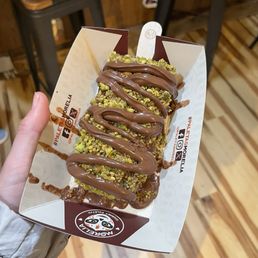 Sicilian Pistachio with hazelnut crunch dip, pistachio and graham cracker topping and Nutella drizzle