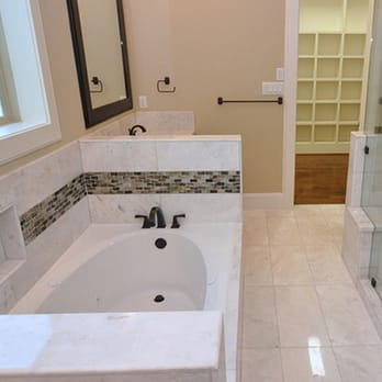 Northwest Construction - a bathtub and shower in a bathroom - General Contractors Near Me Northwest Construction - a bathtub and shower in a bathroom - General Contractors Near Me