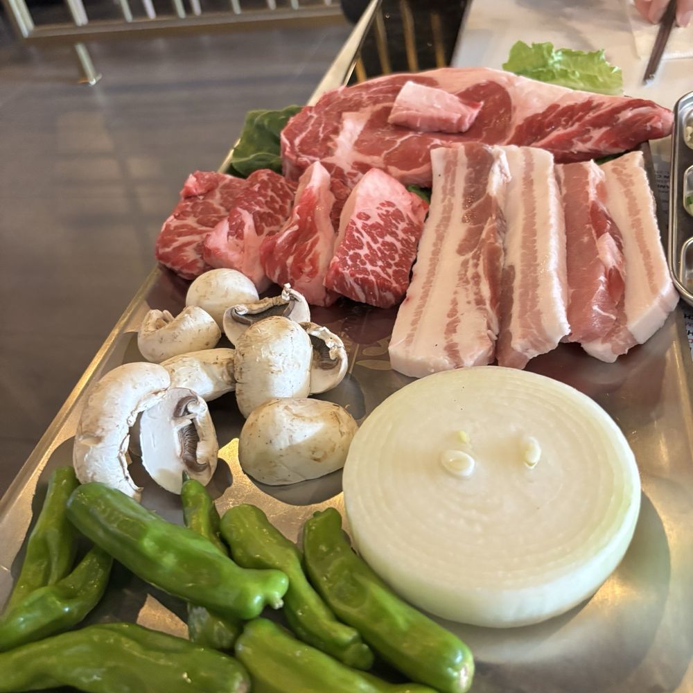 Omi Korean Grill - Foods ready for the grill. Ribeye steak, short rib, and pork belly. Veggies are mushrooms, shishito peppers, and onion - Korean Near Me - Shrewsbury, Massachusetts Omi Korean Grill - Foods ready for the grill. Ribeye steak, short rib, and pork belly. Veggies are mushrooms, shishito peppers, and onion - Korean Near Me - Shrewsbury, Massachusetts