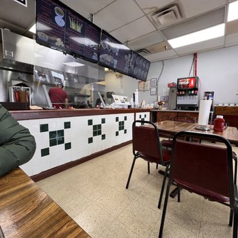 King Gyros - a man sitting at a table in a restaurant - Greek Near Me - Franklin, Tennessee King Gyros - a man sitting at a table in a restaurant - Greek Near Me - Franklin, Tennessee