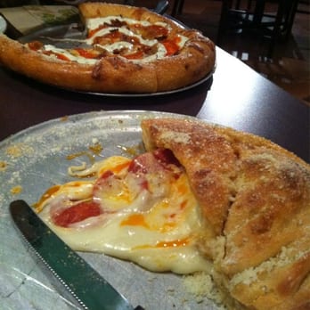 Mellow Mushroom Phoenix - One half of a pepperoni calzone with a small buffalo chicken in the back - Pizza Near Me - Phoenix, Arizona Mellow Mushroom Phoenix - One half of a pepperoni calzone with a small buffalo chicken in the back - Pizza Near Me - Phoenix, Arizona