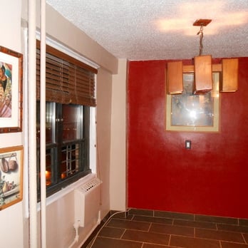 Meador's Top Notch Tile - a hallway with a red wall and a window - General Contractors Near Me Meador's Top Notch Tile - a hallway with a red wall and a window - General Contractors Near Me