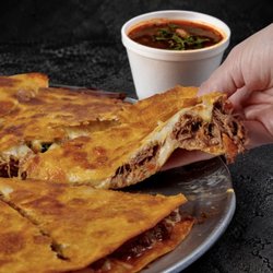 Fuego Cravings - 13" pie filled with mozzarella cheese and our famous birria with onion and cilantro! Served with (2) 8oz consommé.