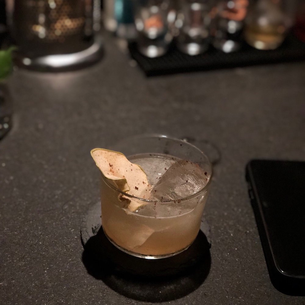 a drink in a glass on a table a drink in a glass on a table