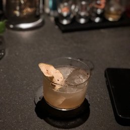 a drink in a glass on a table a drink in a glass on a table