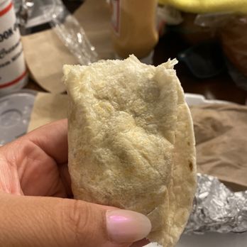 Cook Out - a hand holding a piece of bread - Fast Food Near Me - Shallotte, North Carolina