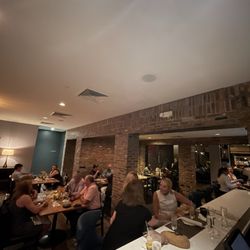 Haven - One end of the L Bar and part of one of the dining rooms into another one with brick walls.