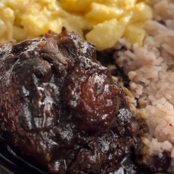 The Jerk Grill - Oxtail bowl: The oxtail is superb, rice and peas flavorful. Unfortunately, the mac and cheese had no flavor at all. - Caribbean Near Me - Redlands, California