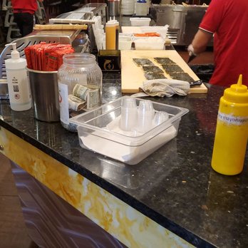 King Buffet - a man preparing food in a restaurant - Buffets Near Me - Orem, Utah