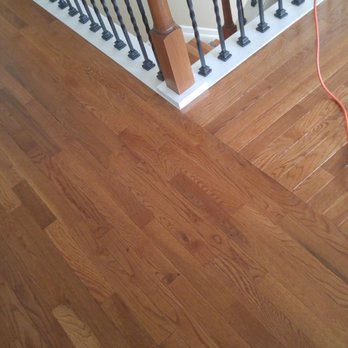 Floor Essence - a hardwood floor being cleaned - Flooring Near Me