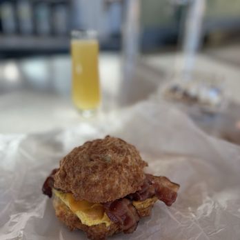 Sunflour Baking Company - #4 Egg, Bacon & Cheddar Sandwich and mimosa - Cafes Near Me - Charlotte, North Carolina Sunflour Baking Company - #4 Egg, Bacon & Cheddar Sandwich and mimosa - Cafes Near Me - Charlotte, North Carolina