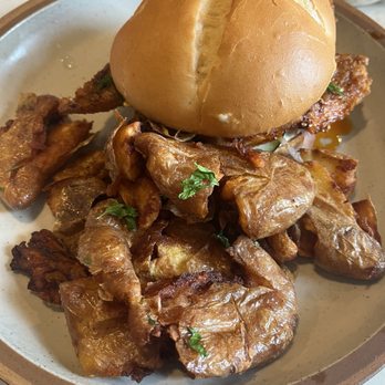 Uncle Wolfie’s Breakfast Tavern - Chili crisp fish sandwich with tavern potatoes - Breakfast & Brunch Near Me - Milwaukee, Wisconsin