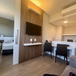 Tauá Hotel Atibaia - The room had a small kitchen with a sofa sleeper. Both the rooms had a TV.