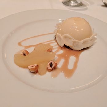 Bacchus - A Bartolotta Restaurant - Mousse dome with hazelnuts, white chocolate petals, and poached pears. - New American Near Me - Milwaukee, Wisconsin Bacchus - A Bartolotta Restaurant - Mousse dome with hazelnuts, white chocolate petals, and poached pears. - New American Near Me - Milwaukee, Wisconsin