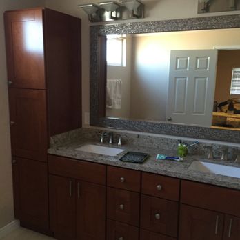 Tomax Construction and Development - "Sleek bathroom remodel featuring a custom tile shower, dual vanities, and rich wood cabinetry." - General Contractors Near Me - Hollywood hills, California