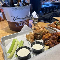 12 bone in baked wings. Nashville Hot & Lemon Pepper rub. Blue cheese. $15 bucket of domestic beers. 12 bone in baked wings. Nashville Hot & Lemon Pepper rub. Blue cheese. $15 bucket of domestic beers.