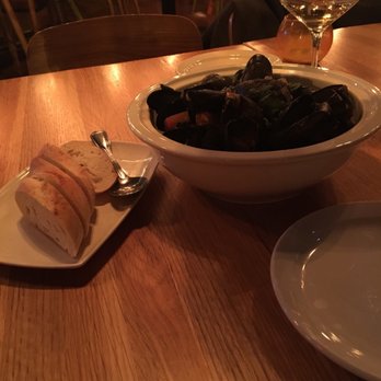 Culaccino Bar + Kitchen - a bowl of mussels and a plate of bread - Italian Near Me - Burlington, Ontario