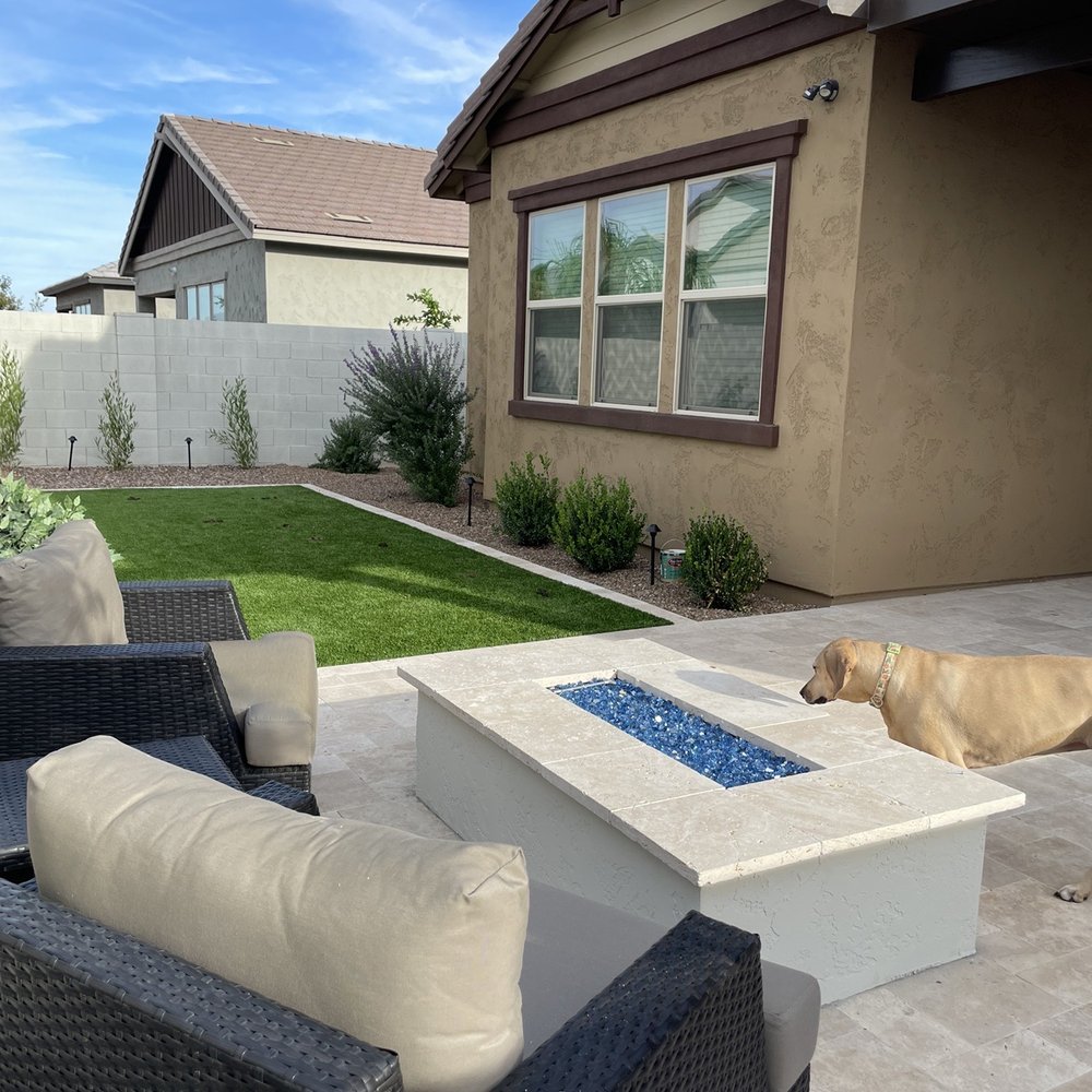 Travertine patio and extension, gas fireplace, turf refresh and border. Also did beautiful raised seating/planter along back and pergola.