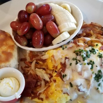 Egg N' Joe - hashbrowns stuffed with scrambled eggs, sausage, bacon, topped with country gravy, a very good biscuit & fresh fruit. - Breakfast & Brunch Near Me - Scottsdale, Arizona