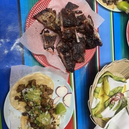 2 spicy pork tacos with a side of ribs 2 spicy pork tacos with a side of ribs