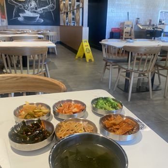 Lucky Soul Diner - Bachan top left to right: daikon, kimchee, broccoli, fish cake, bean sprout, seaweed. Soup front. Noodle making mural in rear. - Korean Near Me - Milpitas, California Lucky Soul Diner - Bachan top left to right: daikon, kimchee, broccoli, fish cake, bean sprout, seaweed. Soup front. Noodle making mural in rear. - Korean Near Me - Milpitas, California