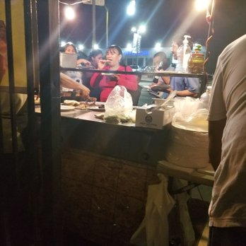 Richards Tacos - a man standing in front of a food stand - Street Vendors Near Me - Los Angeles, California