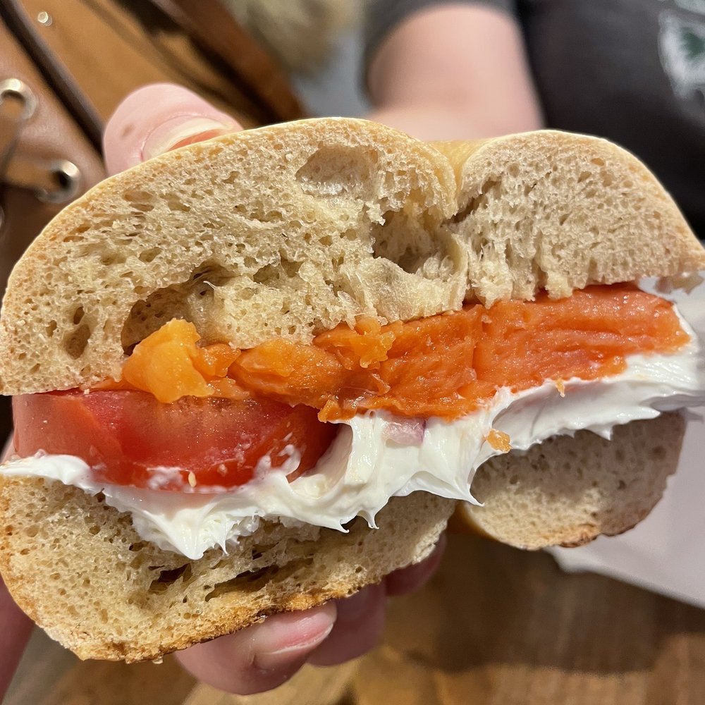 Pearl Street Bagels - a person holding a sandwich - Bagels Near Me - Jackson, Wyoming Pearl Street Bagels - a person holding a sandwich - Bagels Near Me - Jackson, Wyoming