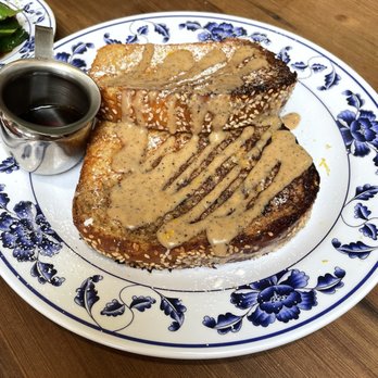 Woon - Milk tea French toast also - Thick slices of French toast with peanut butter and syrup, served on a blue and white floral plate at a restaurant. - Chinese Near Me - Pasadena, California