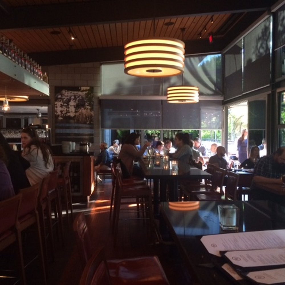 Roaring Fork - Bar area has hightop tables, booths and regular tables. - New American Near Me - Austin, Texas