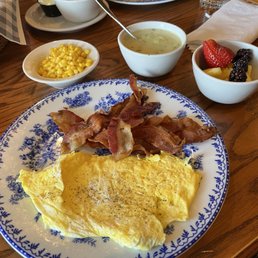 Bacon and eggs, corn, fruit, and turkey gravy to go with the biscuits