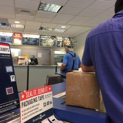 United States Postal Service - One person working and 9 people in line. Workers walk past her not offering to help. What in the world!