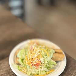 Beef Taquito A La Carte: Shredded Beef Rolled Taquito, Creamy Avocado Mix, Lettuce, Tomato & Shredded Cheddar & MontJack Cheese | $2.5/Each