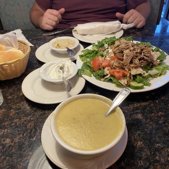 Grape Leaves Restaurant - a man sitting at a table with a bowl of soup and a plate of salad - Middle Eastern Near Me - Troy, Michigan Grape Leaves Restaurant - a man sitting at a table with a bowl of soup and a plate of salad - Middle Eastern Near Me - Troy, Michigan