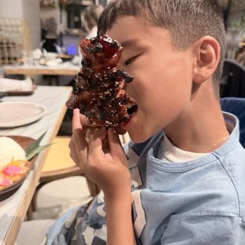 Only At Renee's - Our 8 years old enjoying the grilled BBQ pork skewer - Filipino Near Me - Virginia Beach, Virginia