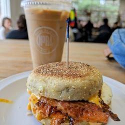 NoRa Cafe - Iced vanilla oat latte and rosemary olive English muffins with bacon and pimento cheese - lifewithhanny