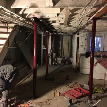 Capital Restoration Management Group - a man working in a basement - Damage Restoration Near Me Capital Restoration Management Group - a man working in a basement - Damage Restoration Near Me