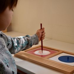 Exploring Minds Montessori School - A child working with the Circle Metal Inset