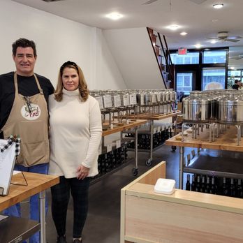 Virgin & Aged - a man and a woman standing in a wine shop - Olive Oil Near Me - Newport, Rhode Island