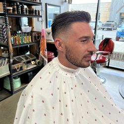 The Barbershop and Shaving Parlor - A guy with a haircut