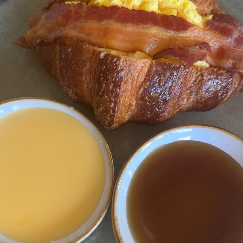 Bacon & egg croissant. Comes with maple syrup and a cheese dip Bacon & egg croissant. Comes with maple syrup and a cheese dip